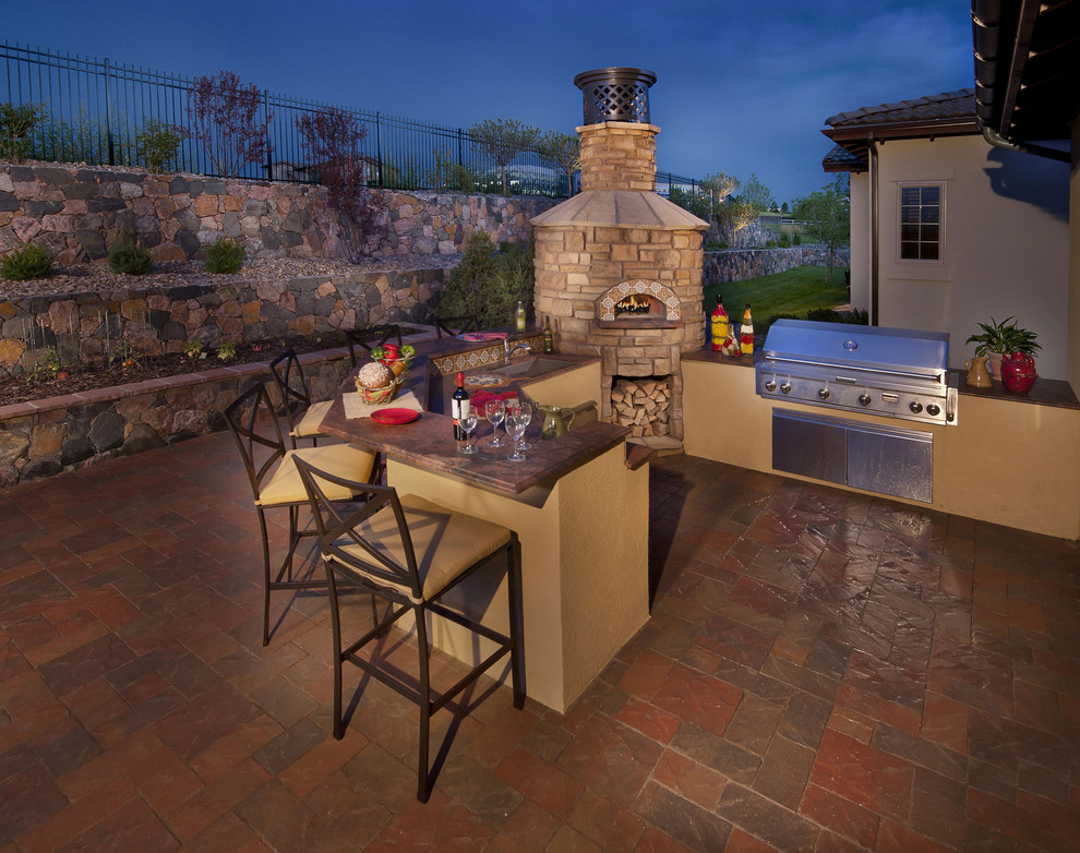 mediterranean rear patio with pizza oven