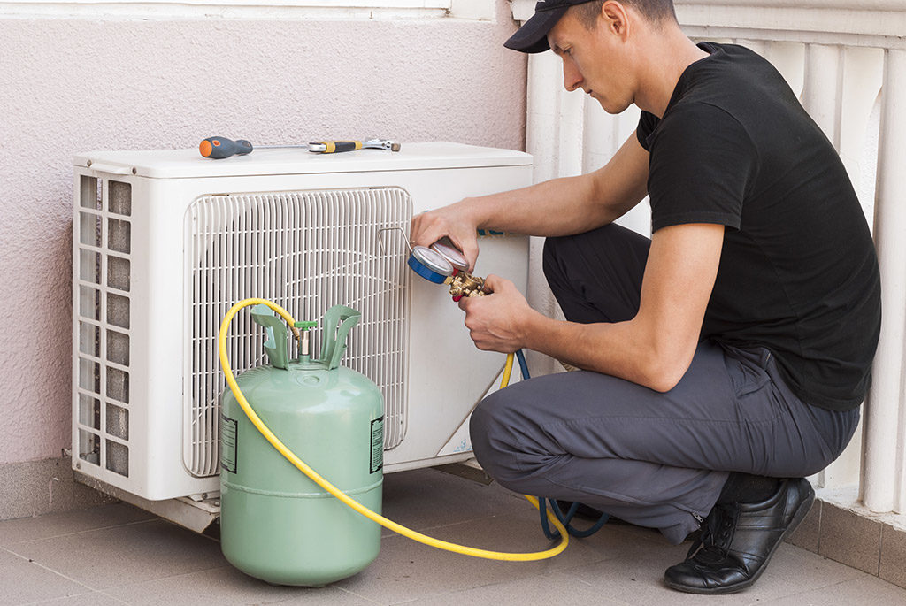 AC technician determining the problem 